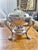 A beautiful antique circa 1910-20s heavy silver plated serving dish on a chafing/warming stand with three oil burners from...