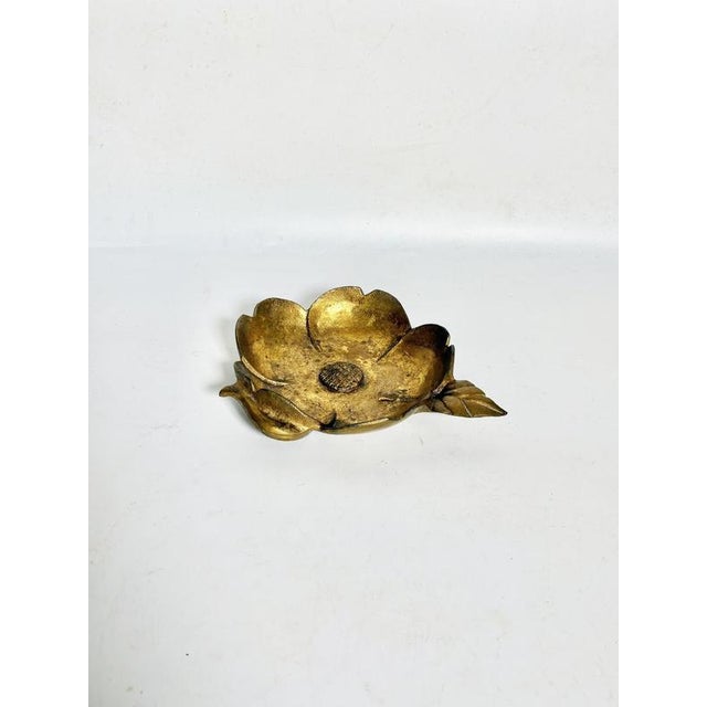 A French bronze ashtray from the 1970s, sculpted in the shape of a blooming flower with delicately modeled petals. The...