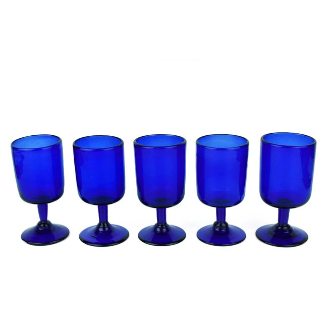 This exquisite set of five mid-20th-century wine goblets features a striking cobalt blue hue that adds a sophisticated pop...