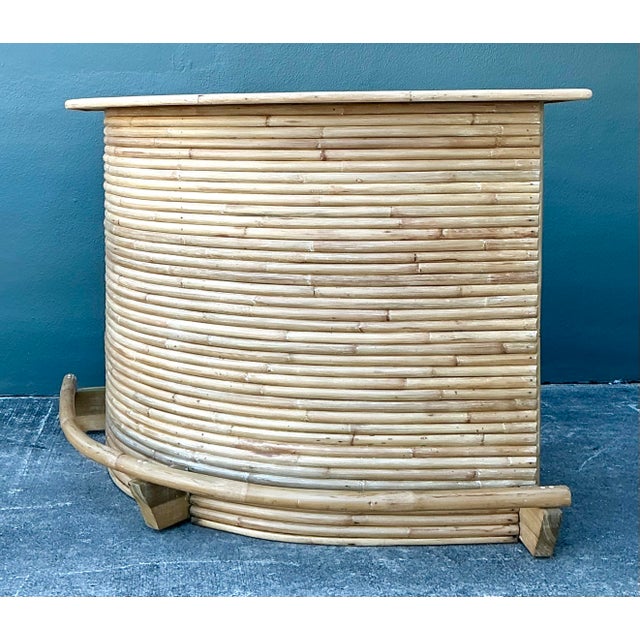 This stunning vintage dry bar is a masterclass in coastal elegance, featuring a dramatic curved facade expertly wrapped in...