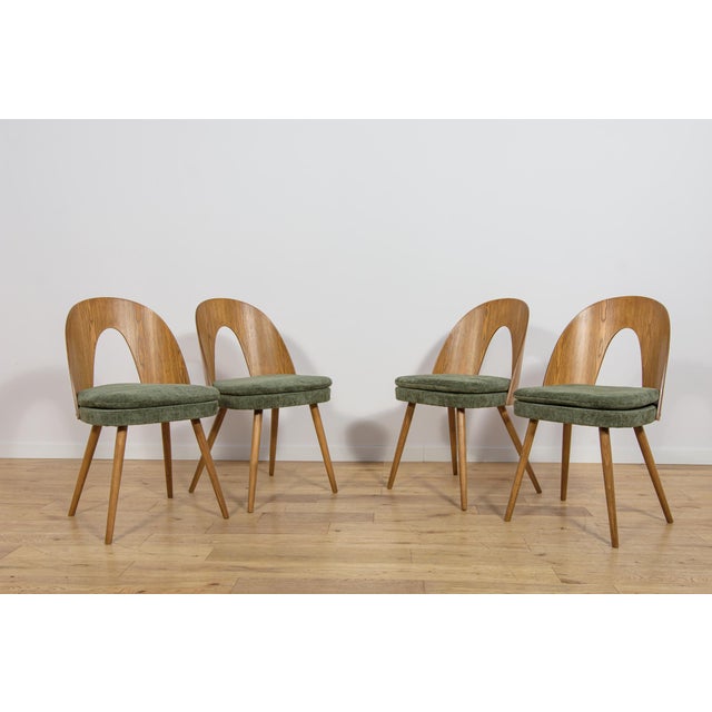 This set of four dining chairs was designed by Antonín Šuman for the Czechoslovak furniture maker MIER Topoľčany during...