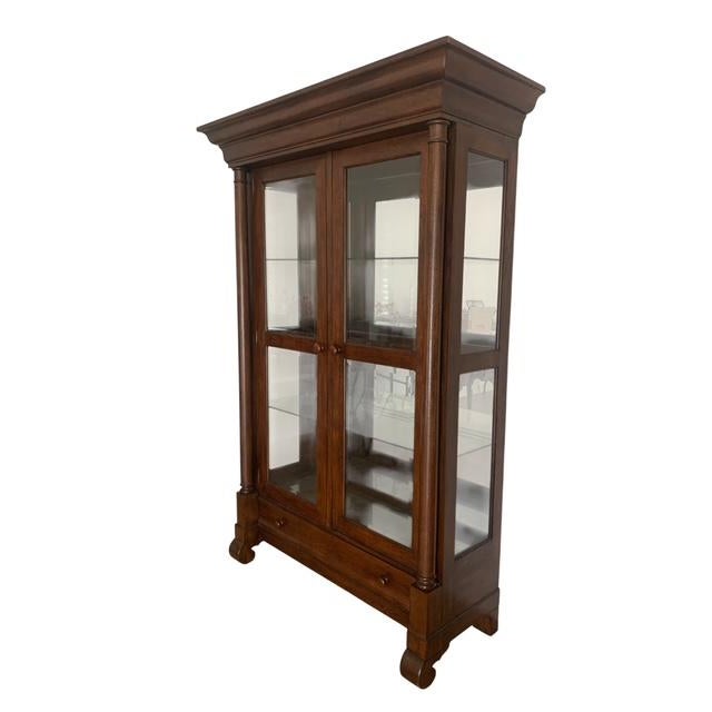 Handsome and striking, this solid wood and glass display cabinet is complete with beveled glass doors and glass shelves;...