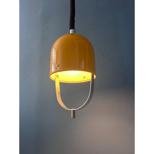 Beautiful vintage Space Age pendant lamp in a vibrant yellow finish, crafted entirely from metal. Its distinctive 1970s...