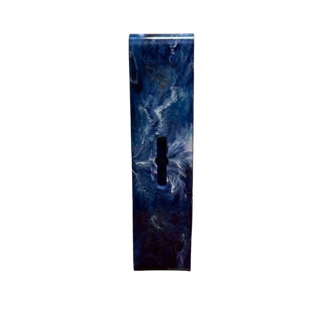 This vintage tabletop vanity mirror features a sculptural square silhouette crafted from richly marbled blue lucite with...