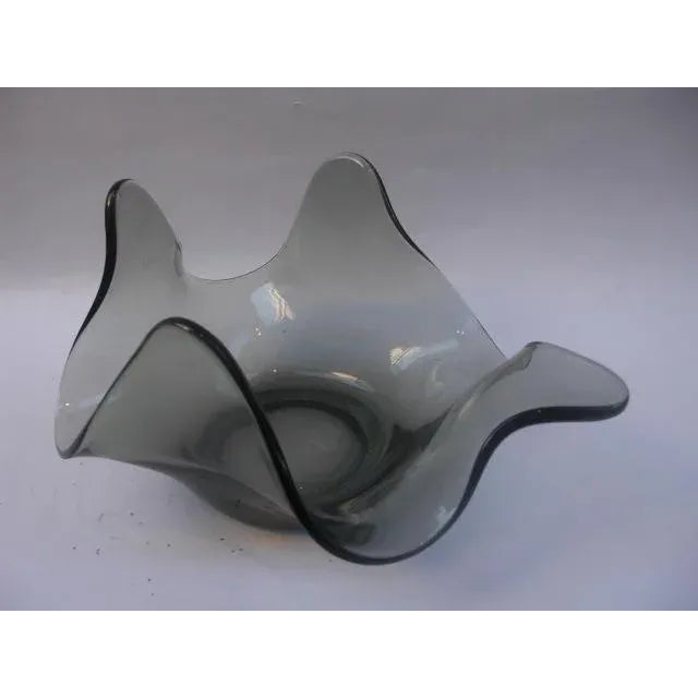 We just love the organic, undulating form of this smoked-colored glass handkerchief bowl, Unsigned.