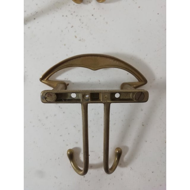Set of four coat hangers with brass hooks. Original vintage item. Very good condition.