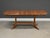 A mid century modern solid teak dining table with two 20” leaves and a pedestal base. We believe it was made in Denmark....