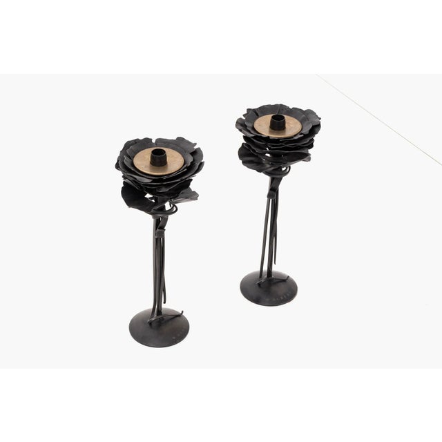 A pair of blossom candle holders by Albert Paley Studio. Forged and blackened steel with brass. Signed and dated [Albert...