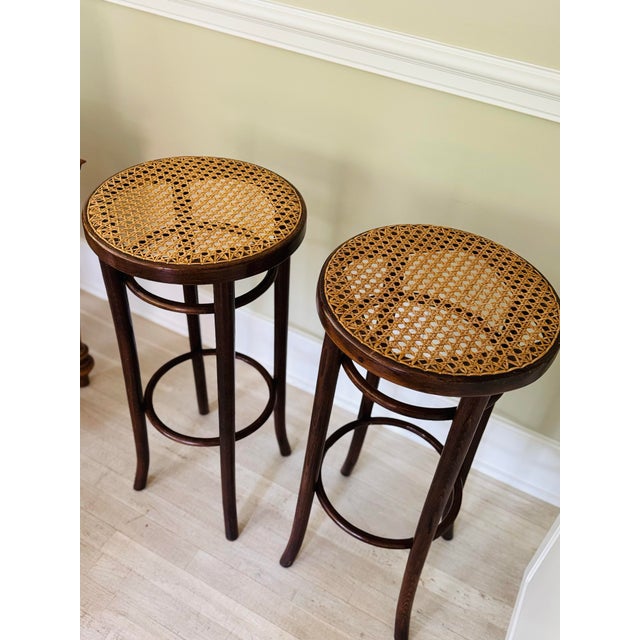 Pair of beautifully preserved Thonet Style Bentwood and Vienna Straw Barstools. The barstools are constructed of bent...