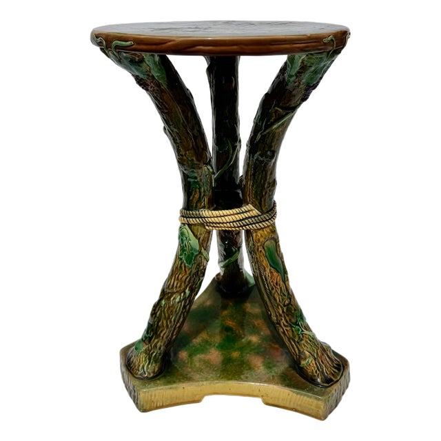 A rare and highly sculptural George Jones majolica faux bois garden seat or drinks table, modeled as entwined tree trunks...