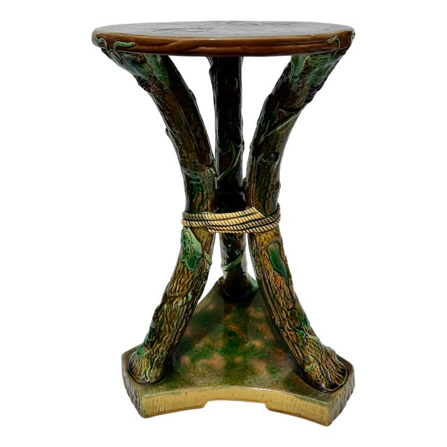 A rare and highly sculptural George Jones majolica faux bois garden seat or drinks table, modeled as entwined tree trunks...
