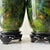 Pristine pair of green floral Chinese cloisonne vases. These 20th century vases feature multi color floral decoration on a...