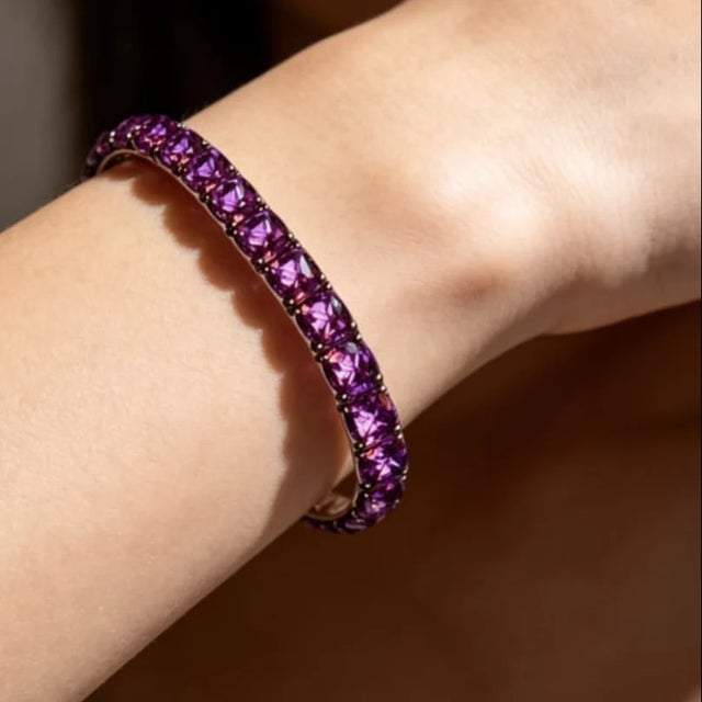This sterling silver .925 flexible bracelet features numerous natural cushion cut amethysts totaling 22 carats . Measuring...