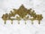 This antique wall coat rack is an exceptional decorative piece made of gold brass with an ornamental design of flowers and...