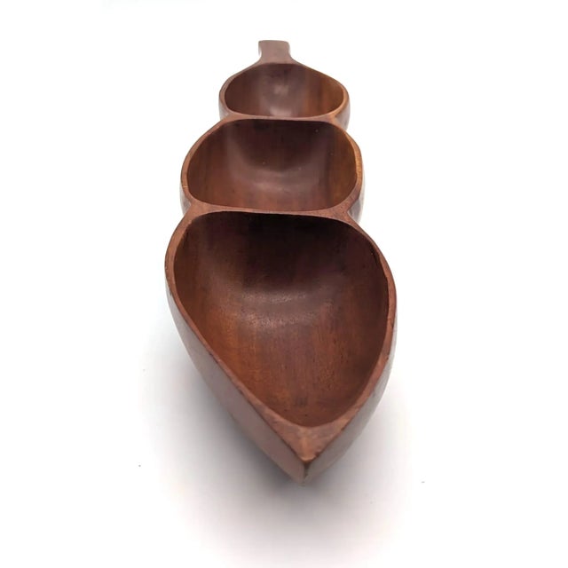Offered is a circa. 1960s Monkey Pod Wood partioned snack bowl for nuts, crudités, etc. It also makes a lovely vide poche...