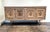 Exceptional, beautifully cerused solid-oak French sideboard/credenza with decorative designs and trim in brass. Finely...