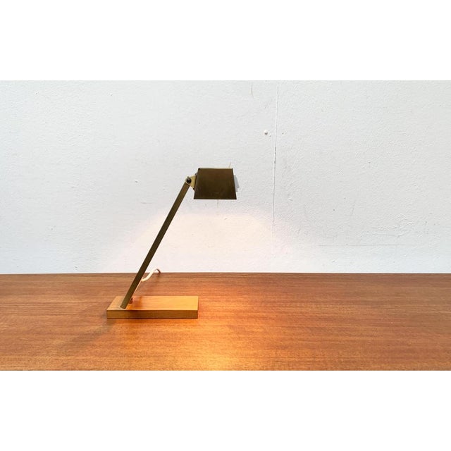 Simple table lamp from Pfäffle. A functional design. The shaft shows an L-shape of flat profiles. The cable is hidden...