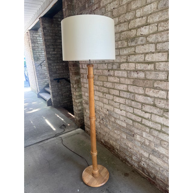 Vintage Danish floor lamp, light wood. This Mid-Century style oak floor lamp features a turned wood column on a round...