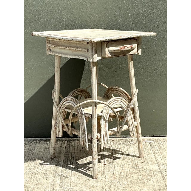 Exuding rustic warmth and authentic folk art charm, this vintage primitive wood side table makes a soulfully aged accent...
