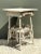 Exuding rustic warmth and authentic folk art charm, this vintage primitive wood side table makes a soulfully aged accent...