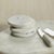 A solid slab of white marble with its smooth, substantial design features an ample, free form accentuated by natural,...