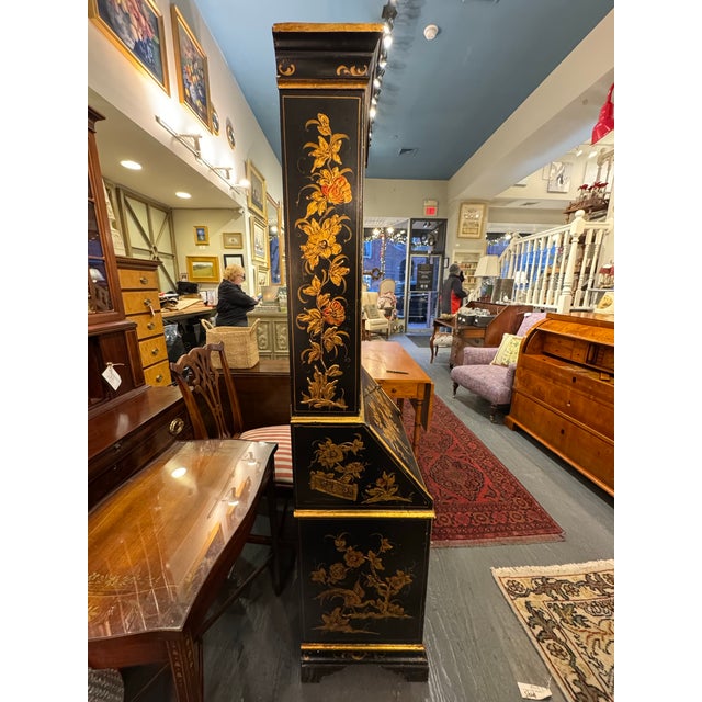 This is a mid 20th century Italian Secretary desk with an arched upper case and a hand painted black lacquer finish. It’s...