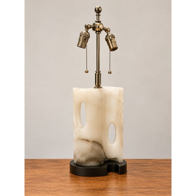 1965-1975 Vintage Carved/Pierced alabaster lamp with a black sculptural base and brass-tone twin-socked hardware. This is...