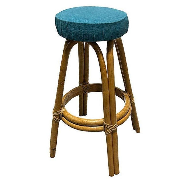 This beautifully restored 1950s single-strand "Arched" Rattan bar stool with padded blue cotton-covered seat. The stool...