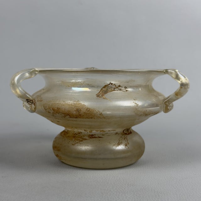 A fascinating piece of Murano glass art that combines design and historical influences. It is a cup-shaped vase (or...