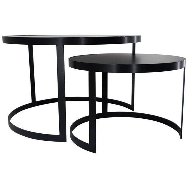 About 21st century set of two iron nesting tables with glass and wood tops, Spain Frame material: Extruded and hand-welded...