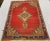 This traditional handwoven Vintage Turkish Oushak rug with an elegant red colored field features a very rare oval-shaped...