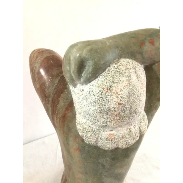 1960s Marble Sculpture Of A Woman With Oversized Hands and textured hair Polished and Raw Stone Surfaces Colors: Red, Green.