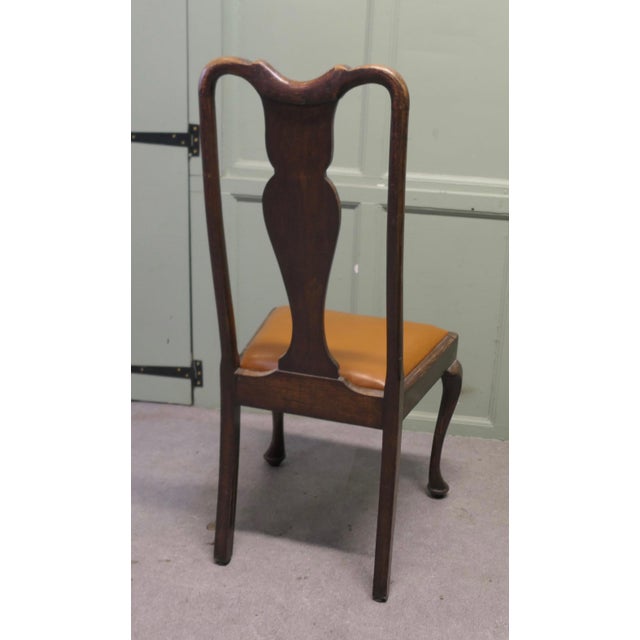 A Set of 4 Queen Anne Style Oak Dining Chairs. A lovely-looking set. The chairs are a classic design and made in oak. They...
