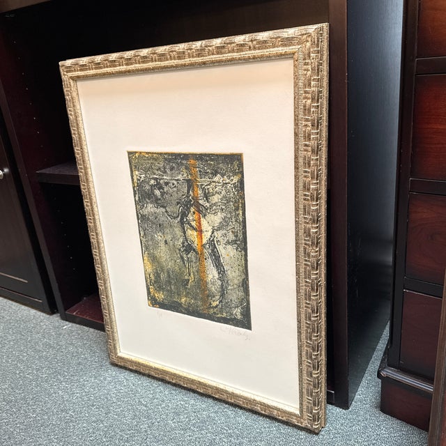 Design Plus Gallery presents an Expressionist Etching with Abstract Figures. The artwork is encased in a silver frame with...