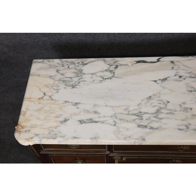 Elegant, sophisticated, and exceptionally well crafted, this magnificent Maison Jansen style neoclassical commode,...