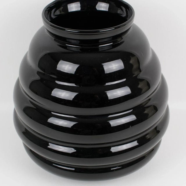 A stunning black glass vase made in Belgium circa 1950. Oversized rounded design with a gadroon shape. Marked underside: "...