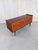 A large chest of drawers made in Italy in the 1950s with quality materials: wood, decorated glass for the top, and brass...