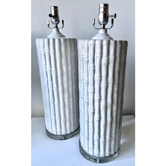 This dramatic set of 2 tall ceramic faux bamboo table lamps feature glass bases with chrome harps and glass finials. Works...