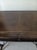 Vintage console writing desk featuring ornate cast metal winged female caryjated legs and dark leather top Style:...