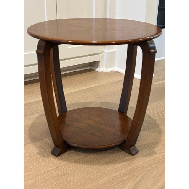 Sculptural American Art Deco occasional table dating to the 1930s, crafted in richly grained quarter-sawn oak with a...