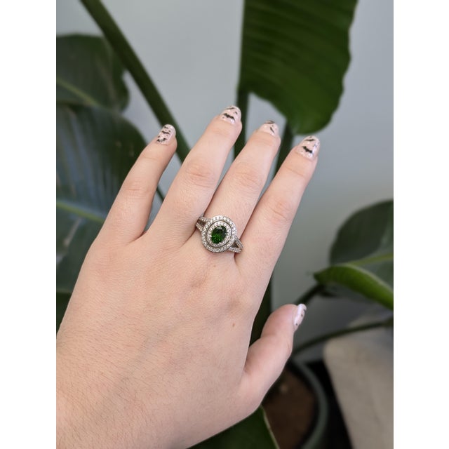 A statement double diamond halo ring that features a deep 1.5 carat chrome diopside center stone, accented along the split...