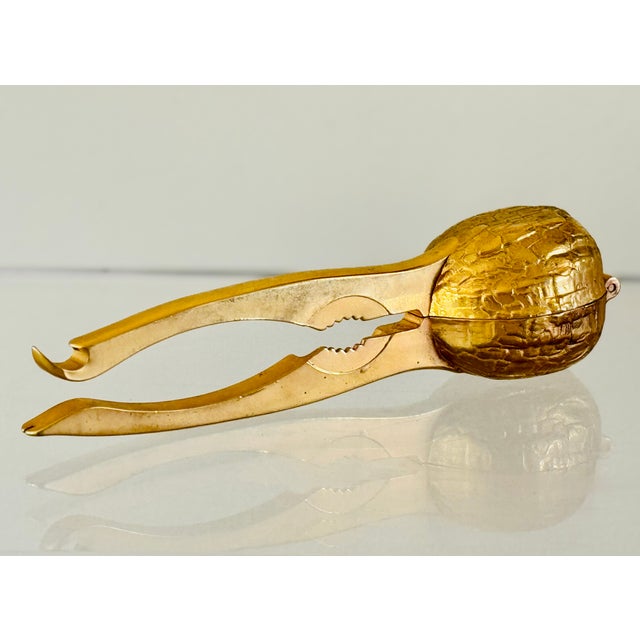 A brass finish nutcracker in the form of a walnut. Marked BMF “Made in W. Germany. From the 70’s.