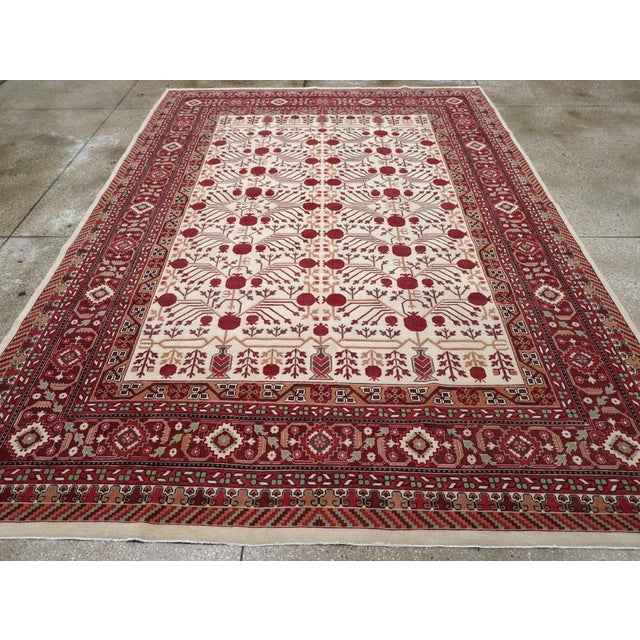 This Mid-20th century East Turkestan Khotan rug, measuring 8' 7" x 12' 1", showcases the refined aesthetic and distinct...