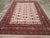 This Mid-20th century East Turkestan Khotan rug, measuring 8' 7" x 12' 1", showcases the refined aesthetic and distinct...