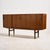 Danish teak highboard with unique handles from the 1960s. The highboard has four sliding doors and a mirror, two small...