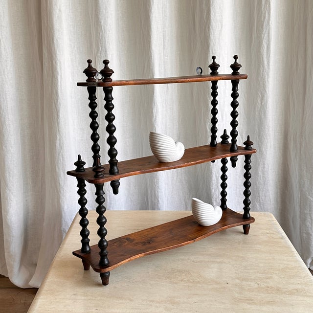 Antique French bobbin wall mounted shelf made of cherry wood. True 19th century country feeling provided by the dark...