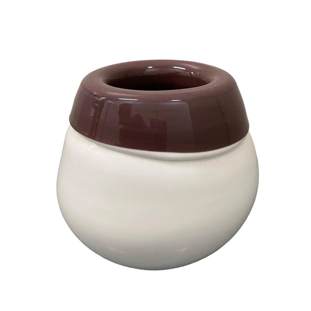 This White glass vase, with a touch of purple-eggplant color ,is a wonderful glass decorative object, realized during the...