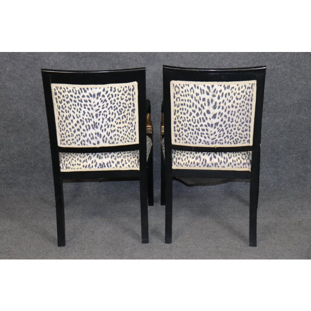 A spectacular and highly decorative set of French ebonized dining chairs in the Louis XVI style, distinguished by dramatic...