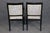 A spectacular and highly decorative set of French ebonized dining chairs in the Louis XVI style, distinguished by dramatic...