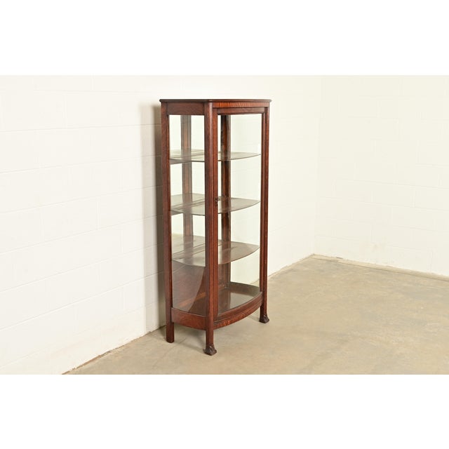 A beautiful antique Victorian, American Empire, or Arts & Crafts bow front bookcase, china cabinet, or display cabinet By...